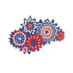 A patriotic paper placemat featuring layered red white and blue starburst designs on a white background.