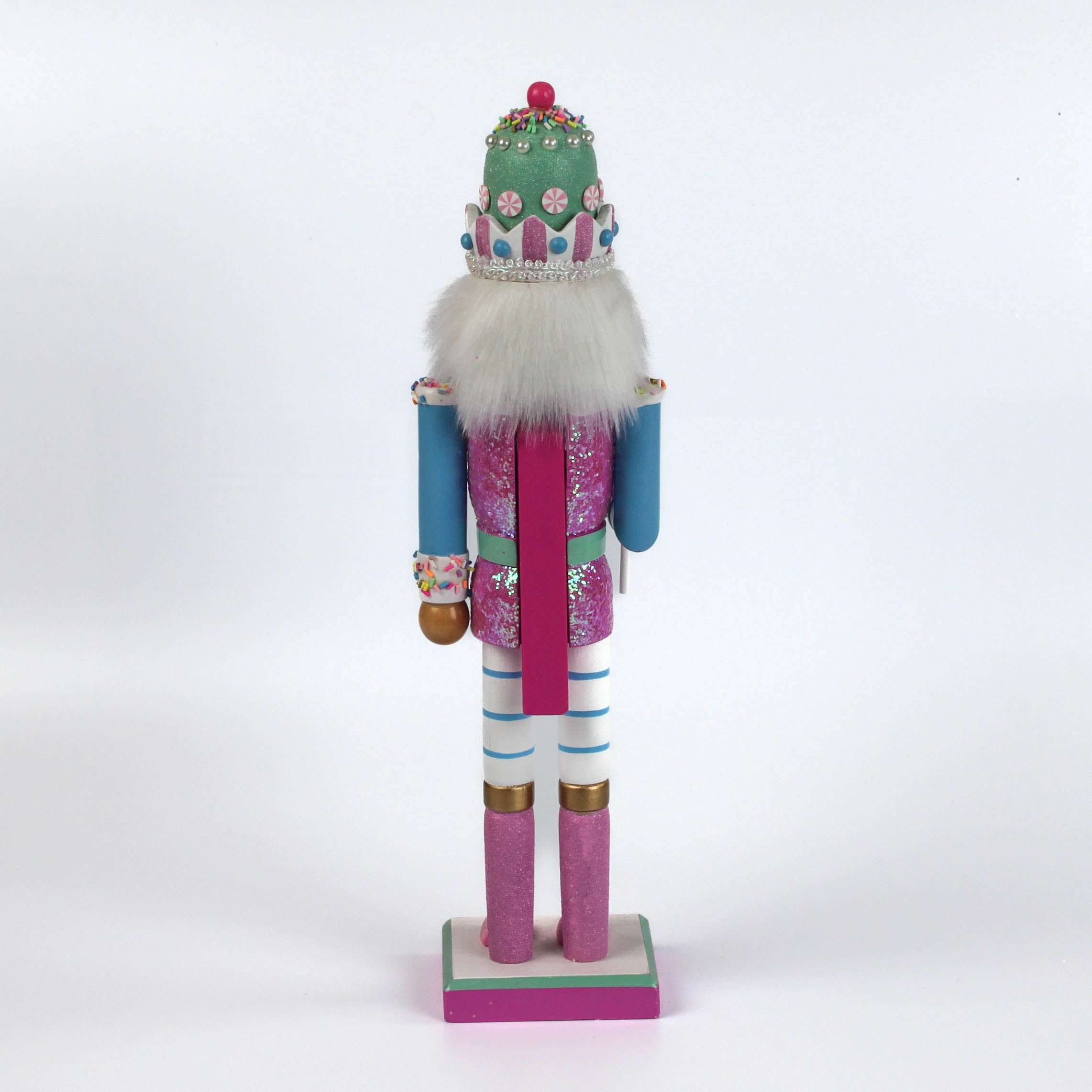 the back of a pink and blue christmas nutracker table decoration on a white background