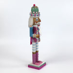 a pink and blue christmas nutracker table decoration on a white background