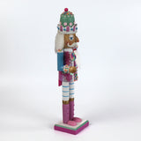 a pink and blue christmas nutracker table decoration on a white background