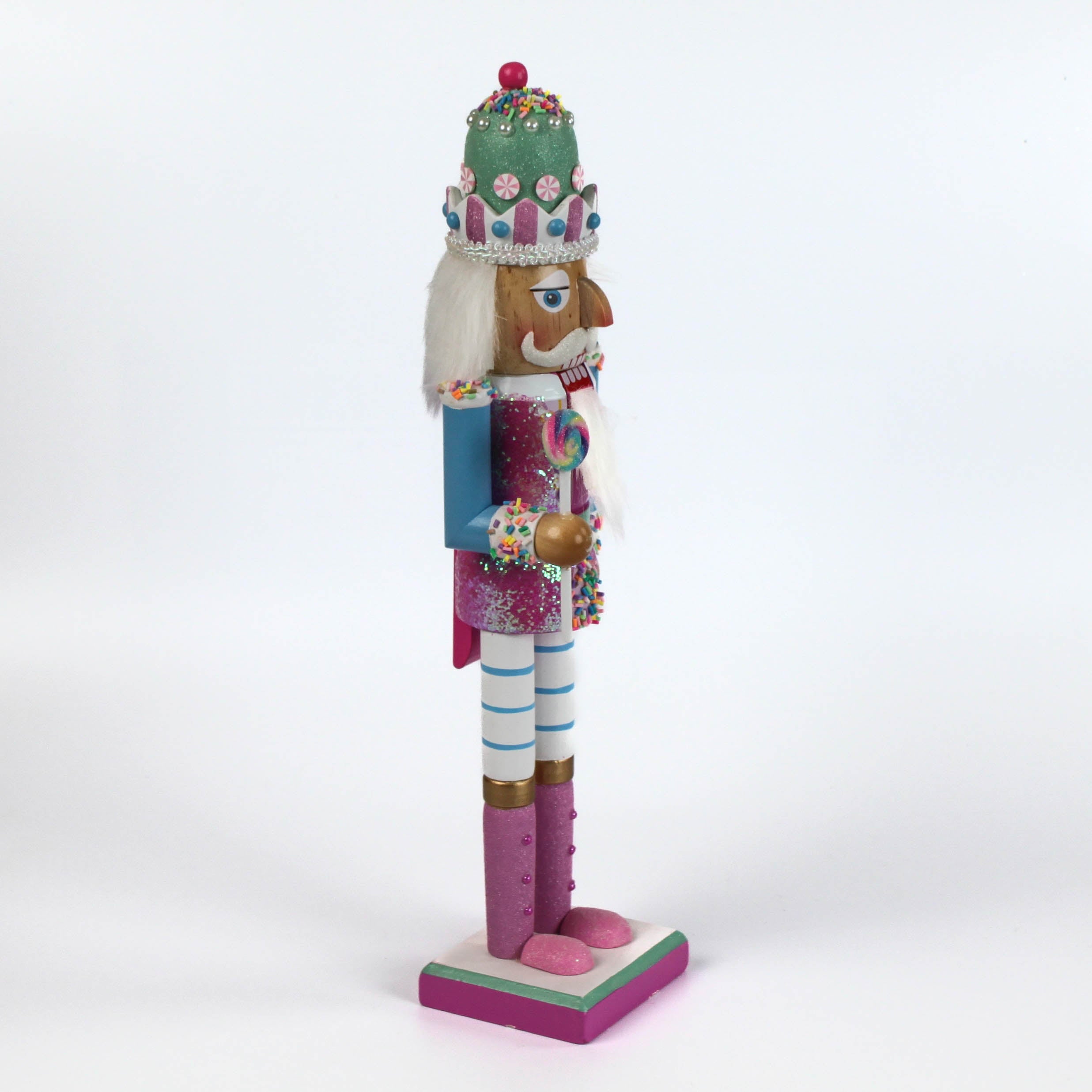 a pink and blue christmas nutracker table decoration on a white background