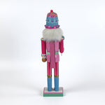 a pink and blue christmas nutracker table decoration on a white background