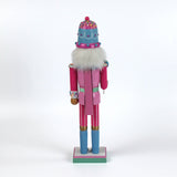a pink and blue christmas nutracker table decoration on a white background