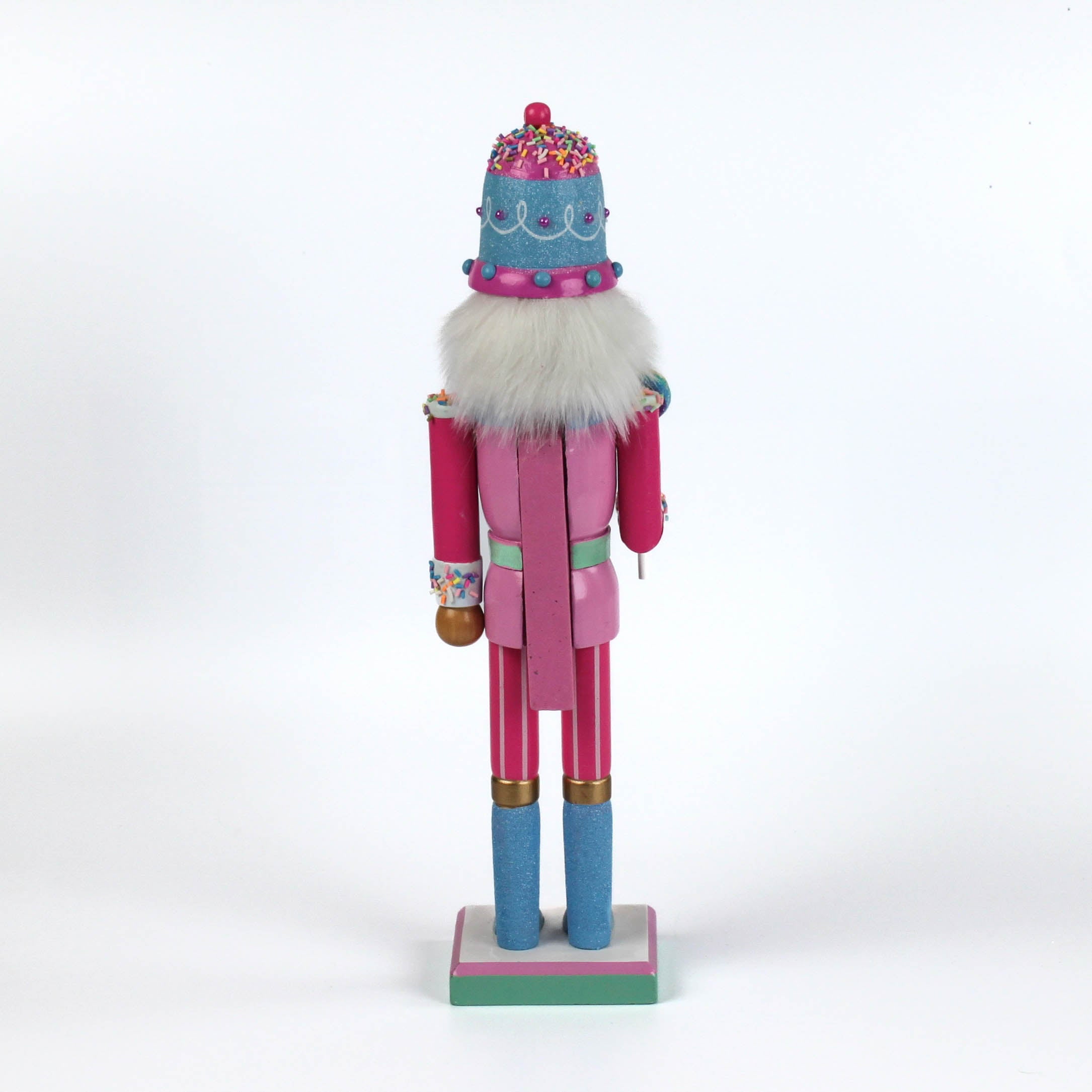 a pink and blue christmas nutracker table decoration on a white background