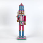 a pink and blue christmas nutracker table decoration on a white background