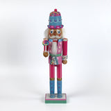 a pink and blue christmas nutracker table decoration on a white background