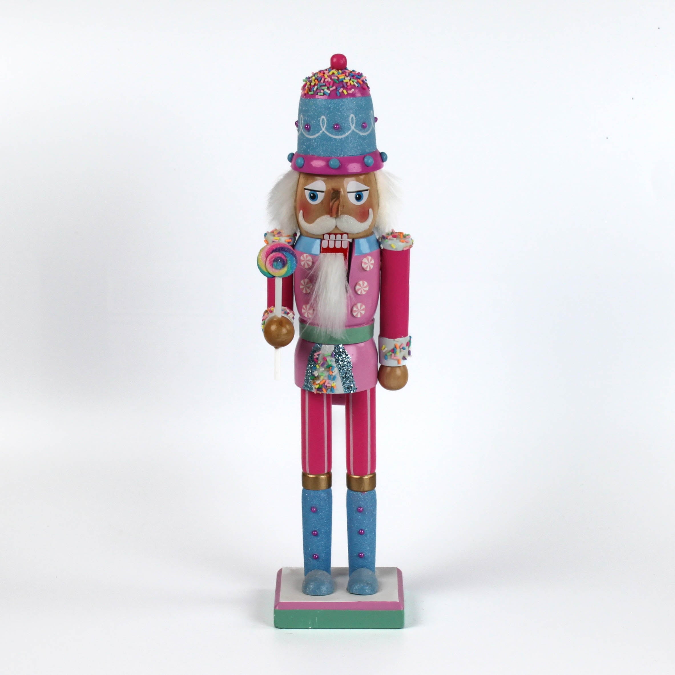 a pink and blue christmas nutracker table decoration on a white background