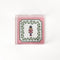 Nutcracker Square Acrylic Tray with in small size with pink and green border and Nutcracker in the center.