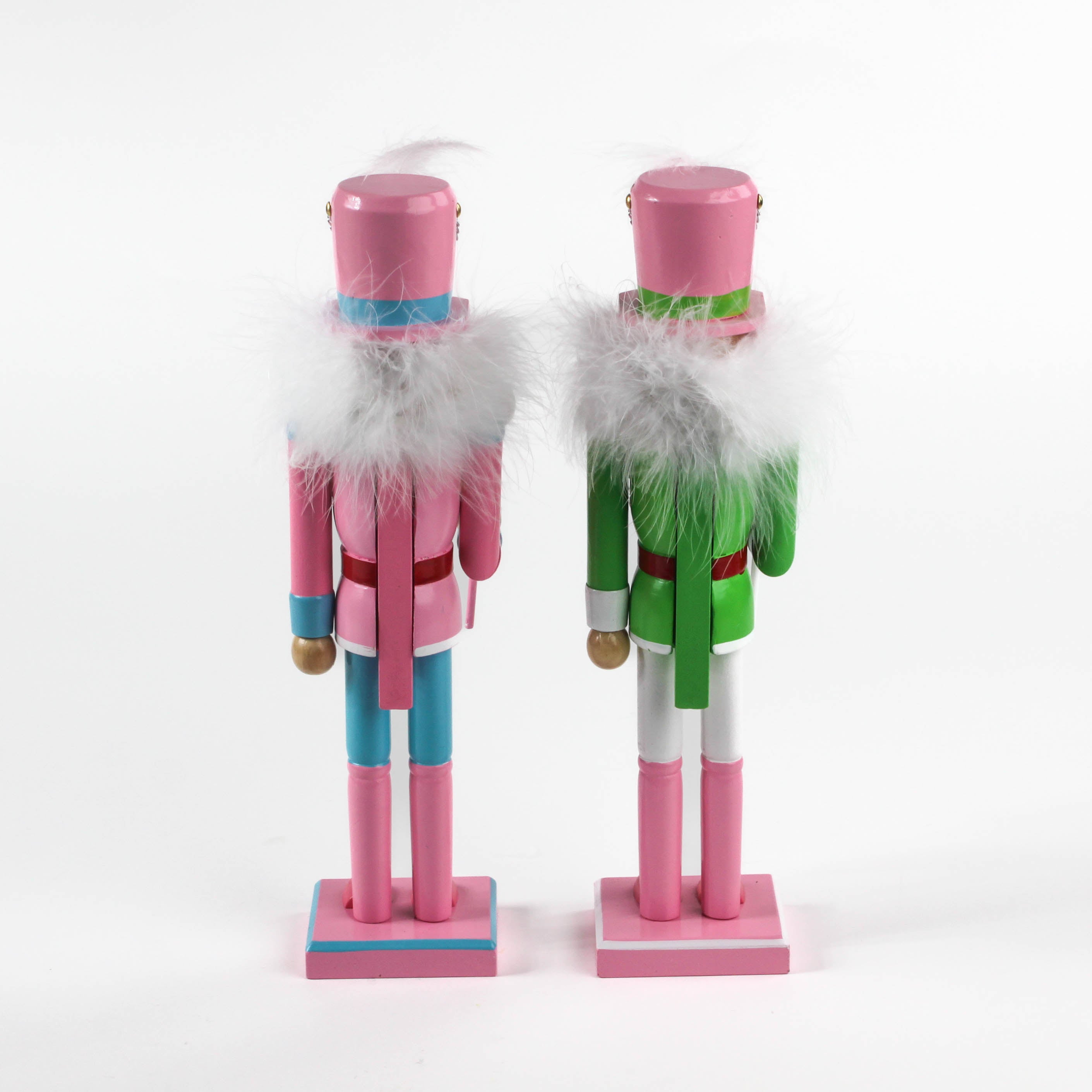 back view of two Pink and Green Christmas Nutcracker Table Decorations against a white background. 