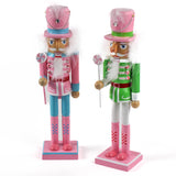 two Pink and Green Christmas Nutcracker Table Decorations against a white background. 