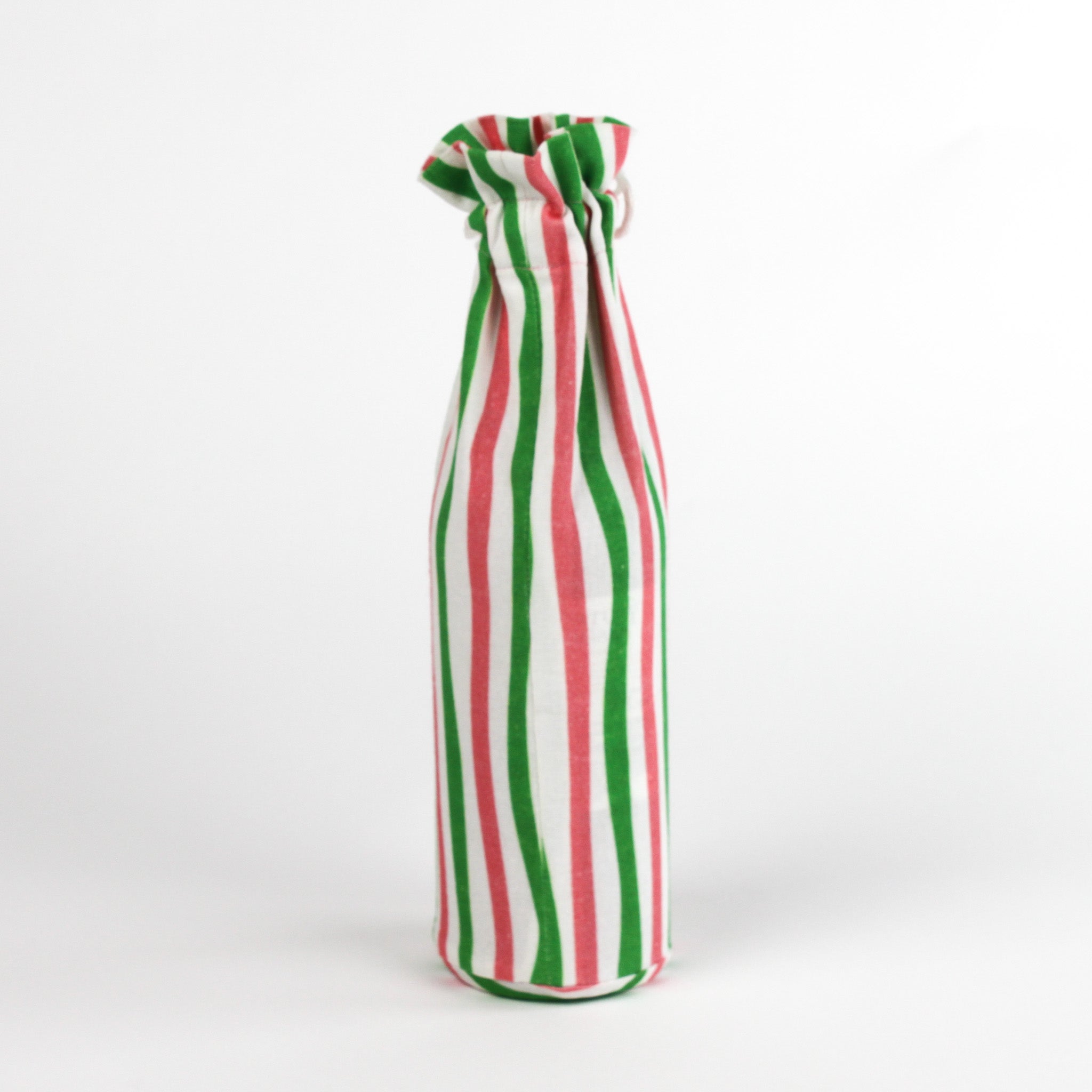 pink, green, and white striped fabric wine bag standing upright