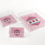 a pink square Acrylic Trays in different sizes with Ornament motifs on them on a white background