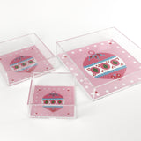 a pink square Acrylic Trays in different sizes with Ornament motifs on them on a white background