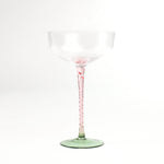 an elegant pink Stem Coupe Glass with a green bottom in white background