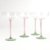 a set of 4 elegant pink Stem Coupe Glass with a green bottom in white background
