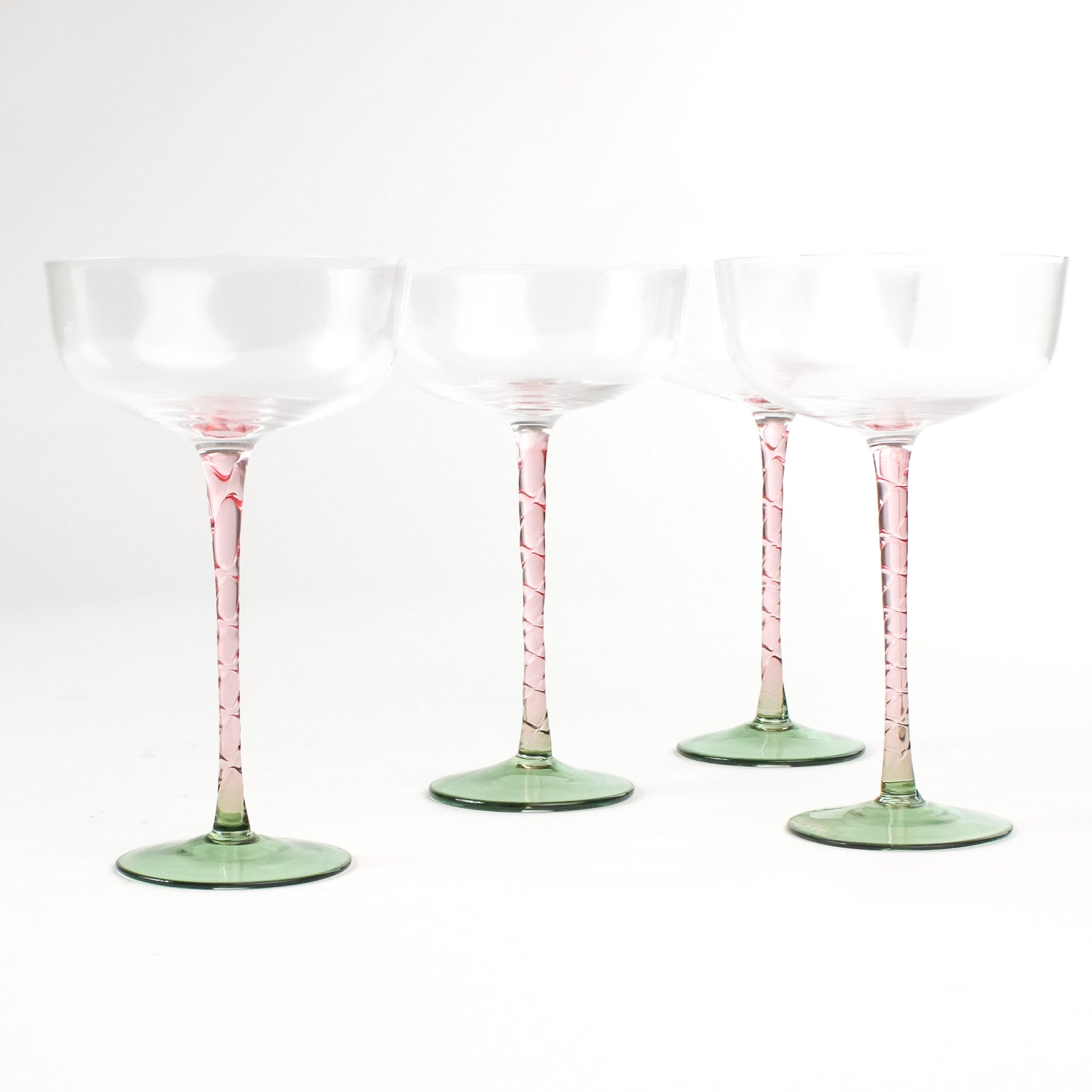 a set of 4 elegant pink Stem Coupe Glass with a green bottom in white background