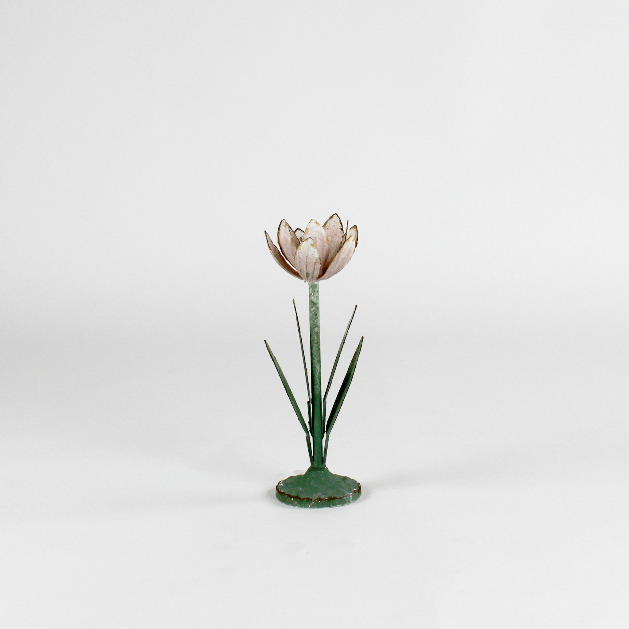 a large metal flower candle holder in the shape of a pink lily on a white background