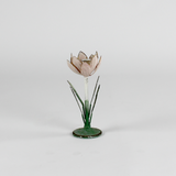 a small metal flower candle holder in the shape of a pink tulip on a white background