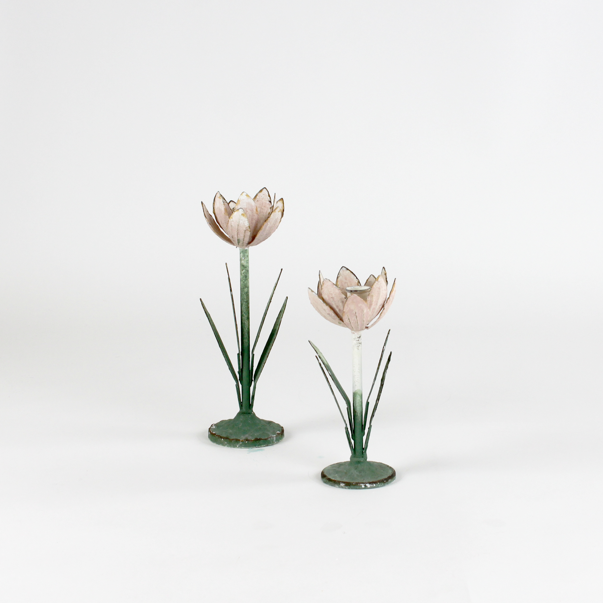Two decorative metal Pink Tulip flower sculptures on a white background
