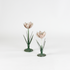 Two decorative metal Pink Tulip flower sculptures on a white background