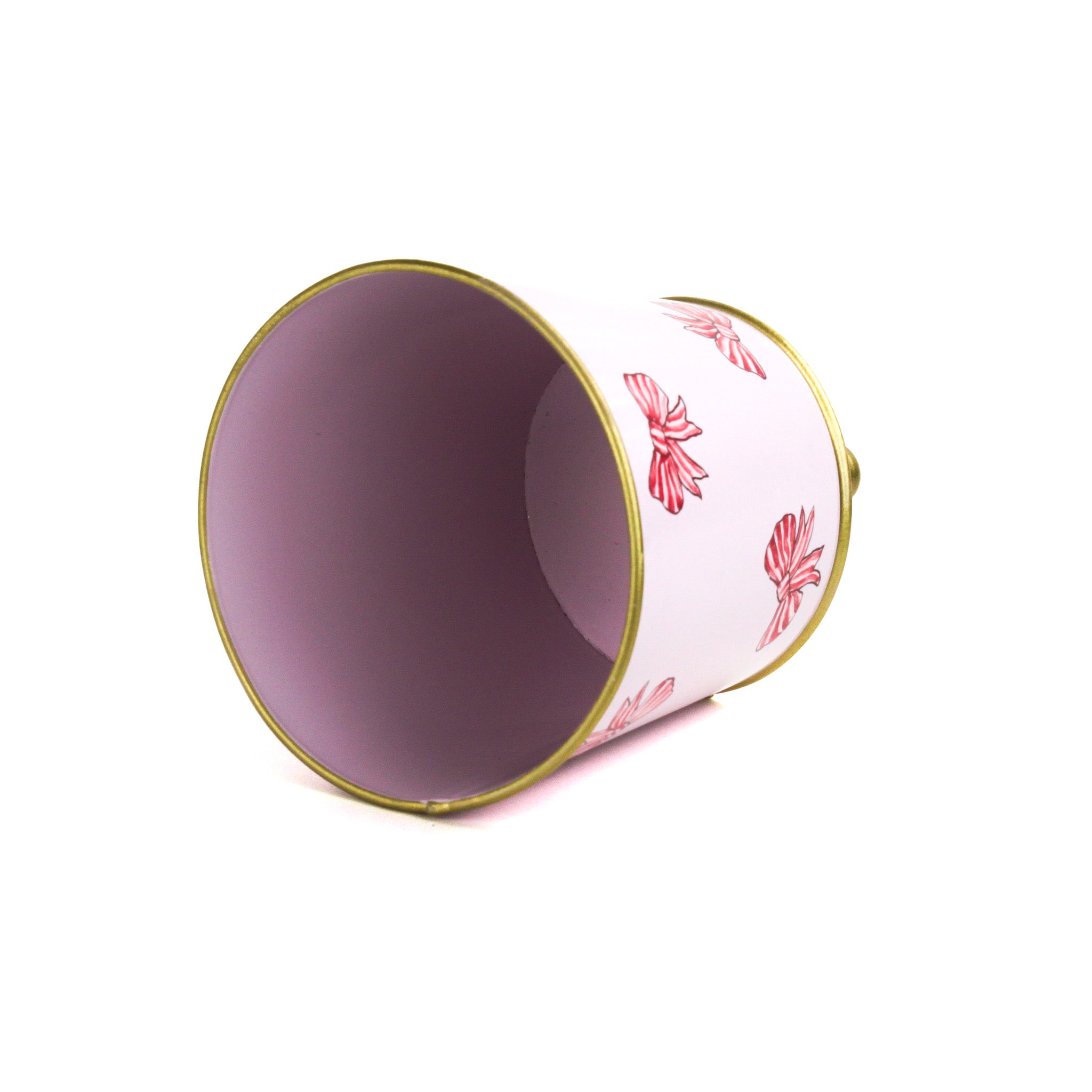 Pink tole cachepot with gold trim and striped bow design, shown on its side to display interior.