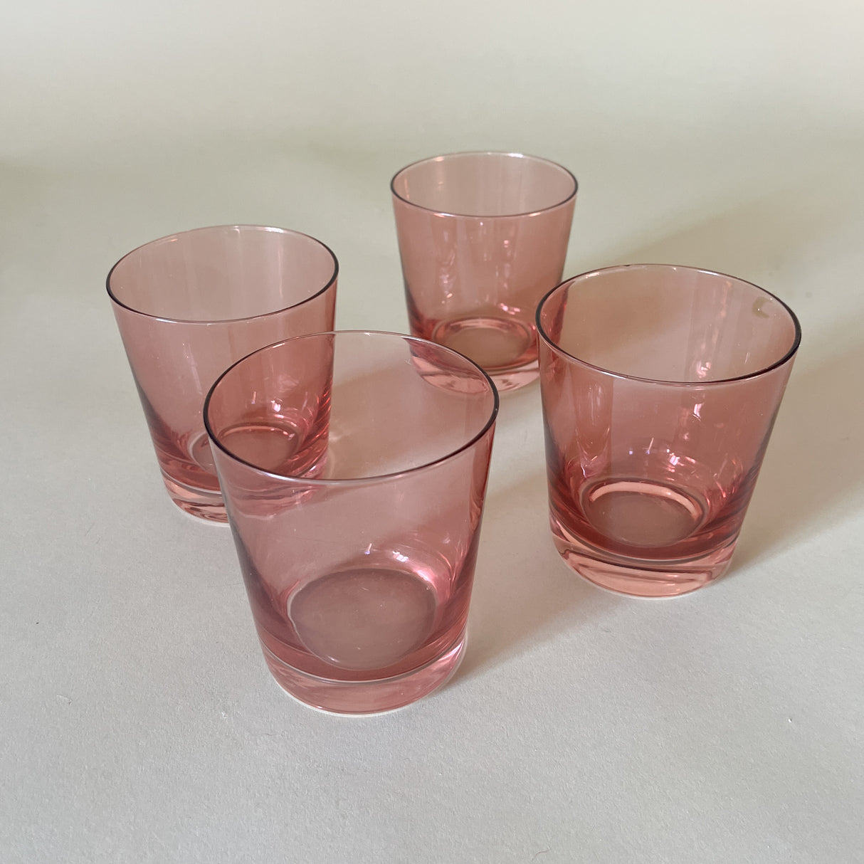 a set of four pink colored drinking glasses from madcap cottage