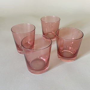 a set of four pink colored drinking glasses from madcap cottage