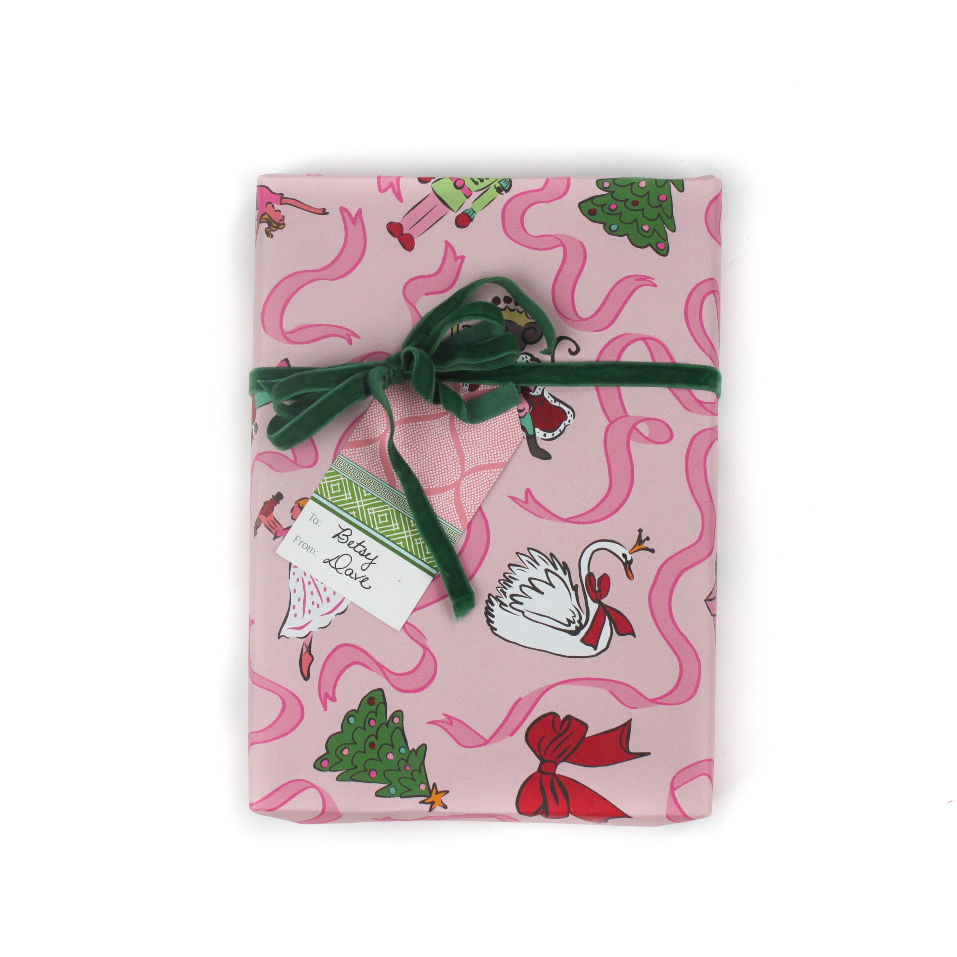 Pink Christmas wrapping paper featuring nutcracker and ribbon motifs.