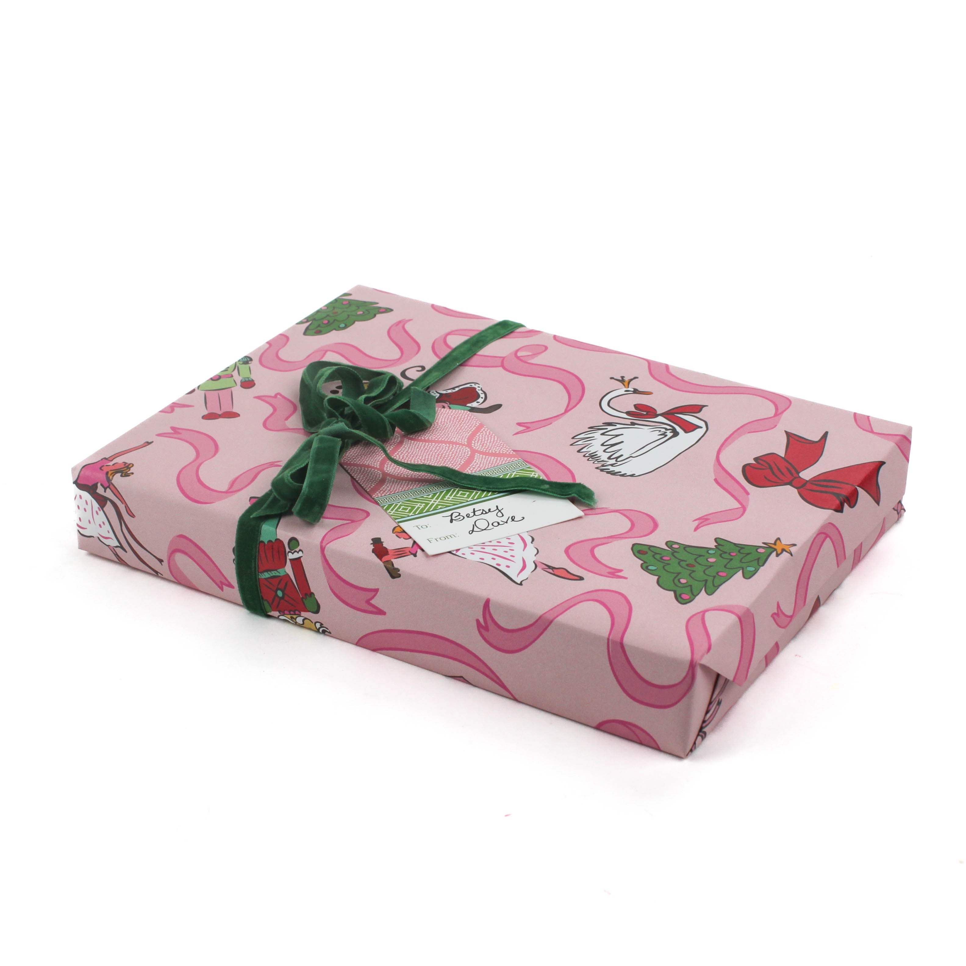 Pink Christmas wrapping paper featuring nutcracker and ribbon motifs.