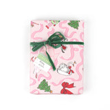 Gift wrapped in pink nutcracker Christmas paper with green velvet ribbon and matching gift tag.