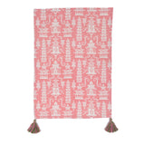 a pink chinoiserie tea towel with white pagodas and green and pink tassels in the corner resting on a white background. 