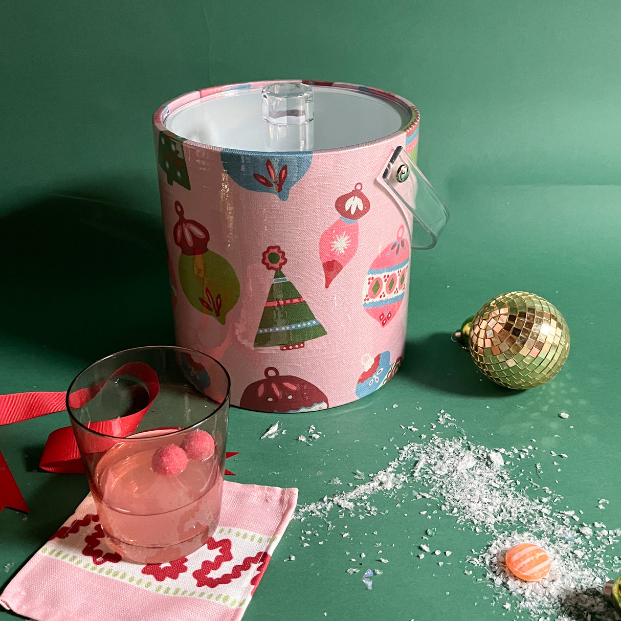 A pink ice bucket decorated with ornament motifs