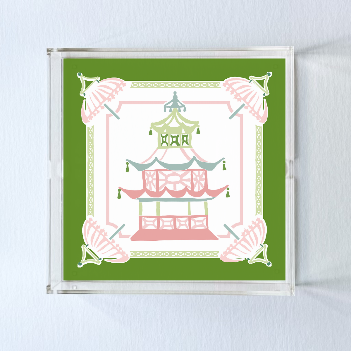 An acrylic tray featuring a green border and central pagoda motif. 