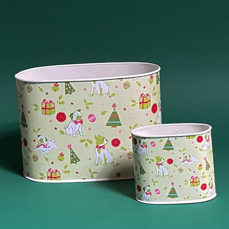 Two Pug Perfection decoupage caddies with a Christmas-themed design featuring pugs, trees, and gifts in green and white colors.