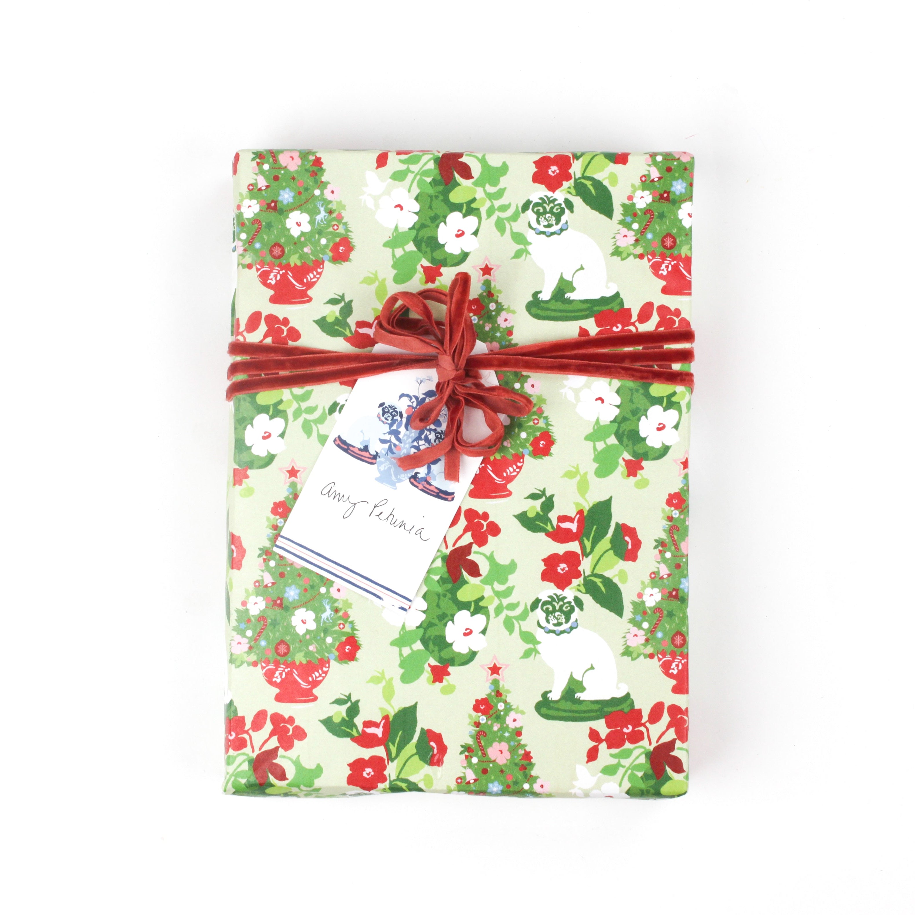 Top view of gift wrapped in Pug gift wrapping paper with red ribbon.
