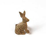 a metal gold bunny napkin rings on a white background. 
