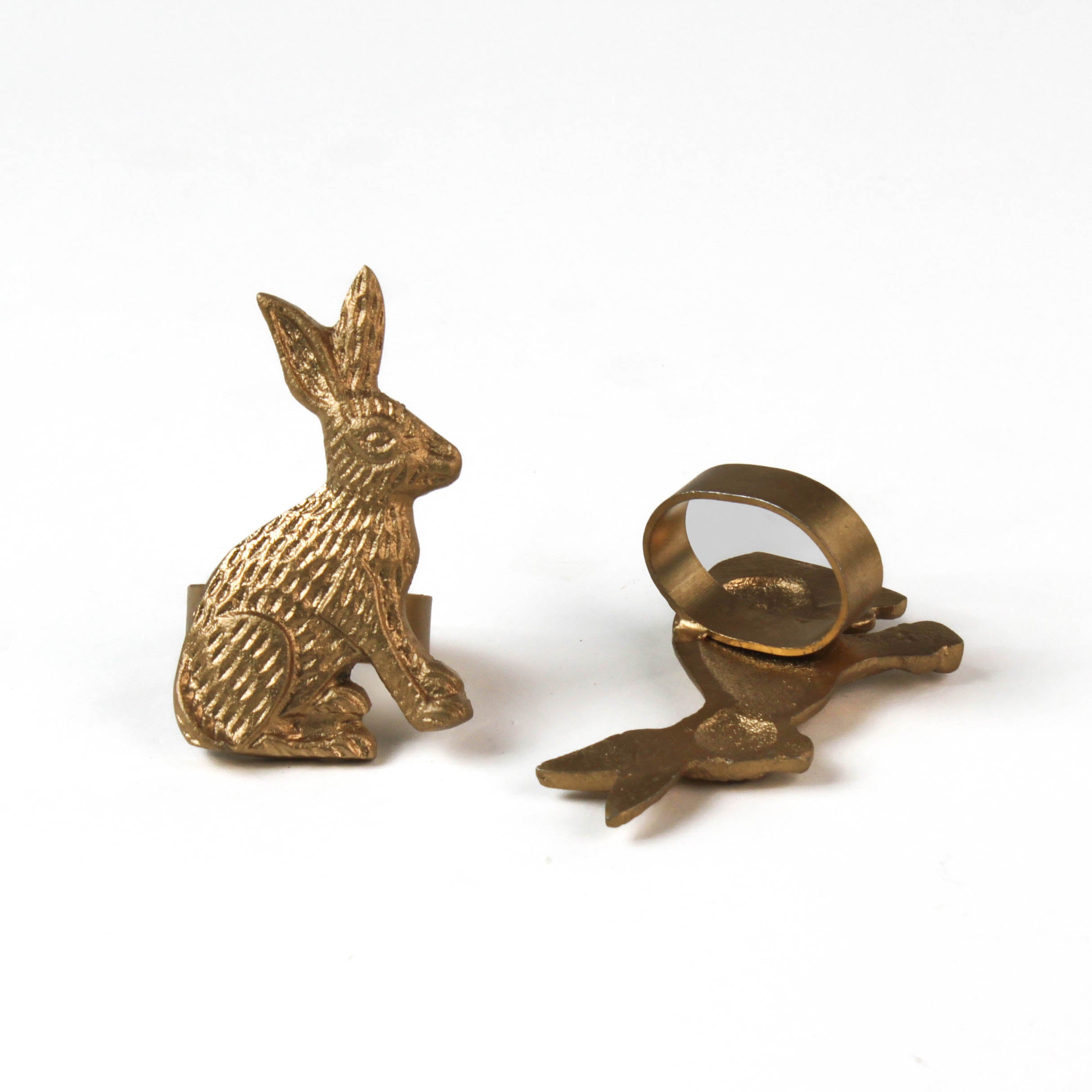 two metal gold bunny napkin rings on a white background. 