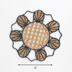 Round rattan placemat with blue shell design and natural woven center, 15 inch diameter