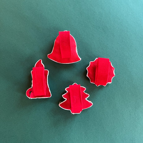 Rear view of Vintage Satin Christmas-Icons Napkin Rings on a green background