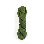 a recycled torn-silk ribbon in green laid in a white surface