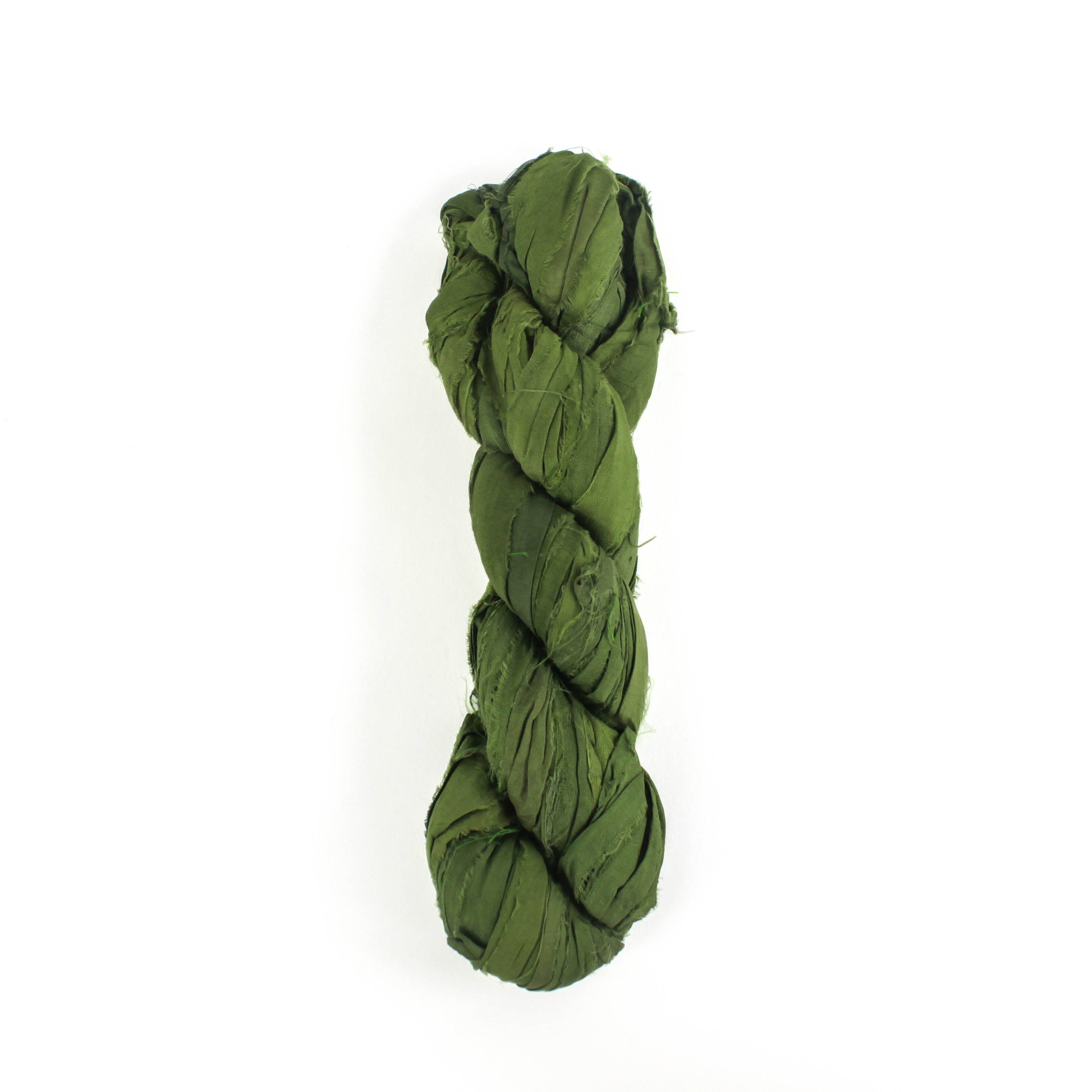a recycled torn-silk ribbon in green laid in a white surface