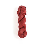 a recycled torn-silk ribbon in pink laid in a white surface