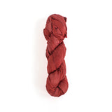 a recycled torn-silk ribbon in pink laid in a white surface