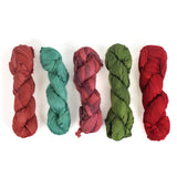 5 sets of recycled torn-silk ribbon in different colors laid in a white surface