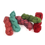 5 sets of recycled torn-silk ribbon in different colors laid in a white surface