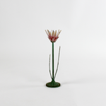 a large metal flower candle holder in the shape of a red lotus on a white background
