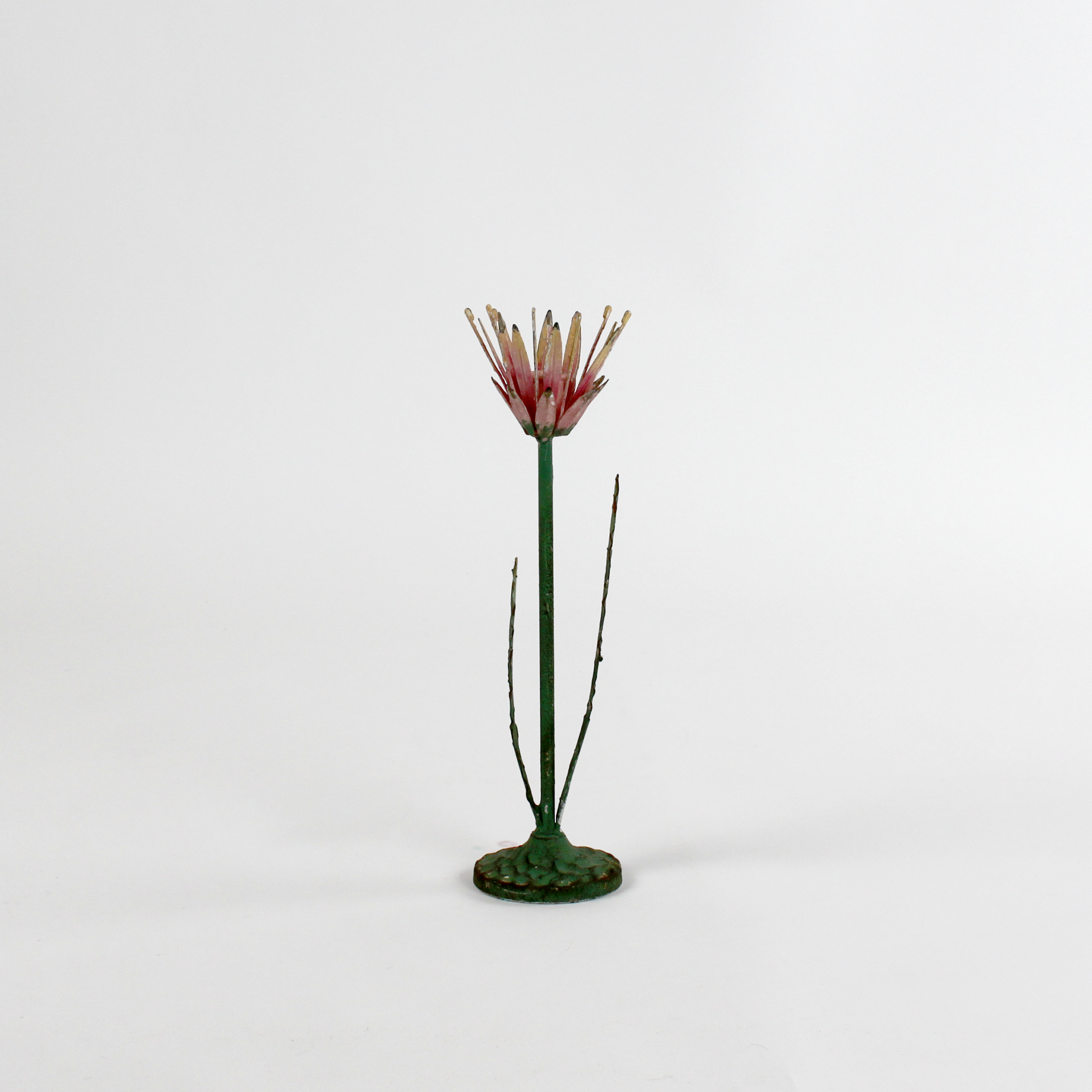a large metal flower candle holder in the shape of a red lotus on a white background
