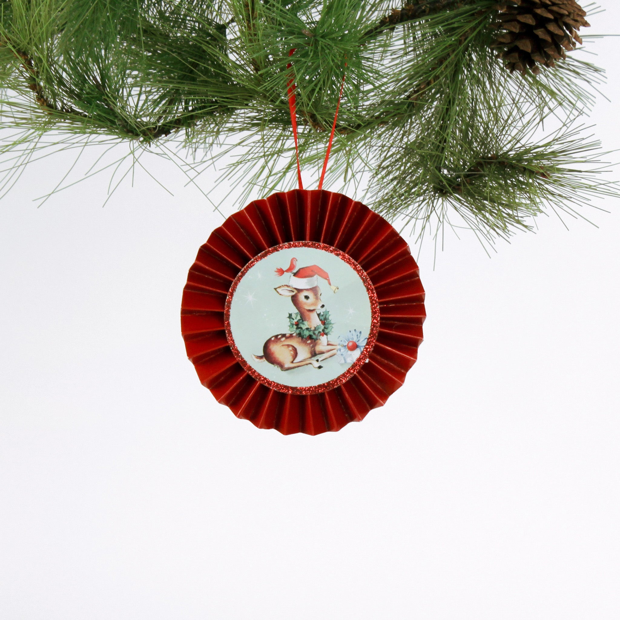 retro-style ruffled paper Christmas ornaments featuring vintage illustration, accented with red pleated borders and hanging ribbons