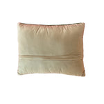 the reverse side of a green tennis pillow with two green crossed rackets.