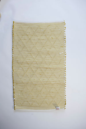 the reverse side of A cotton blue accent rug with a repeating diamond motif from Madcap Cottage. 
